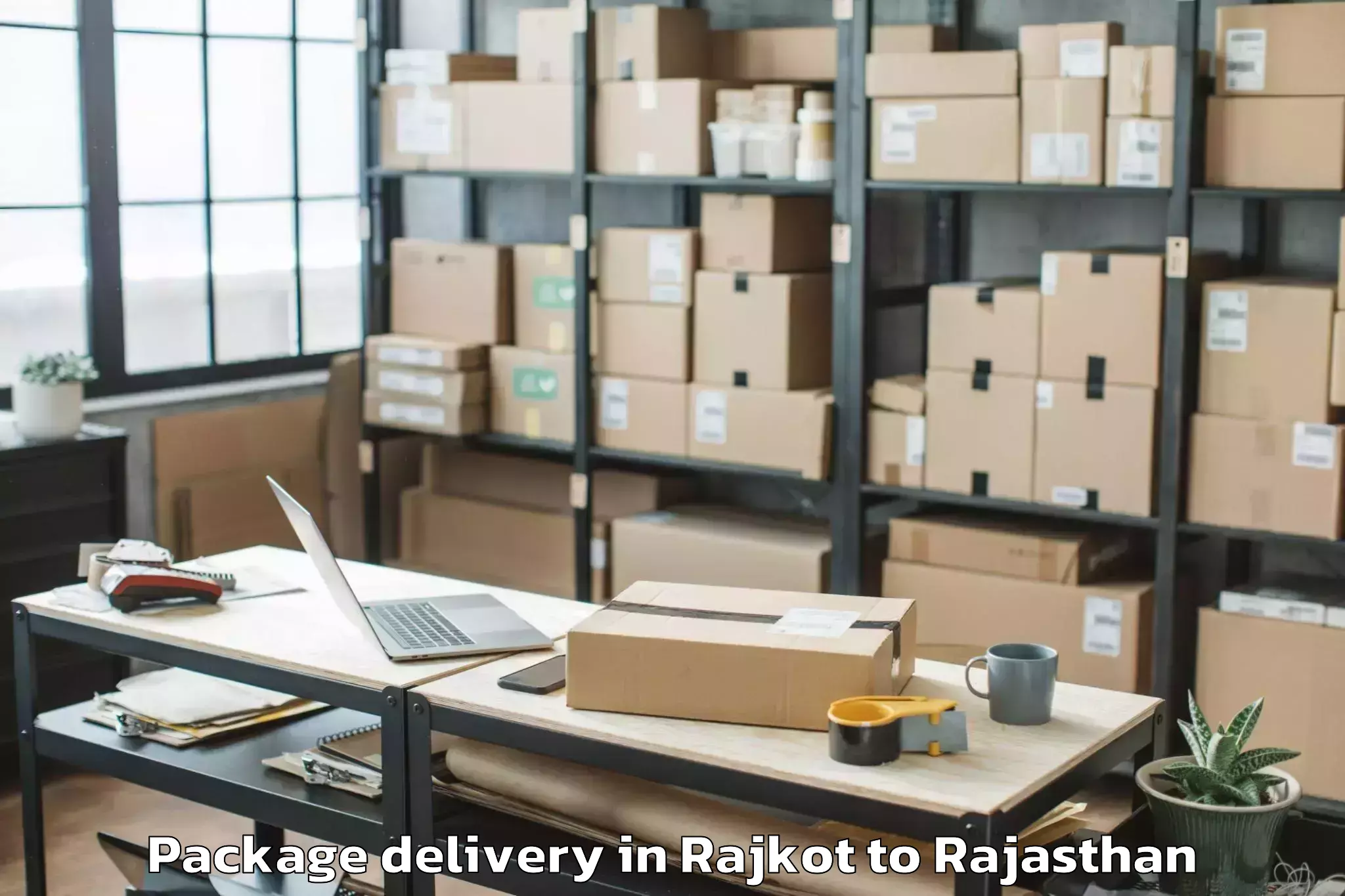 Reliable Rajkot to Opjs University Churu Package Delivery